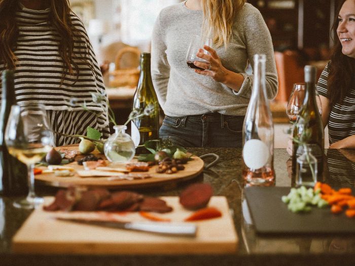 a gathering of people with charcuterie boards