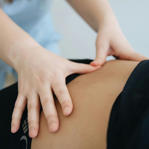 chiropractor hands on lower back pressure points 