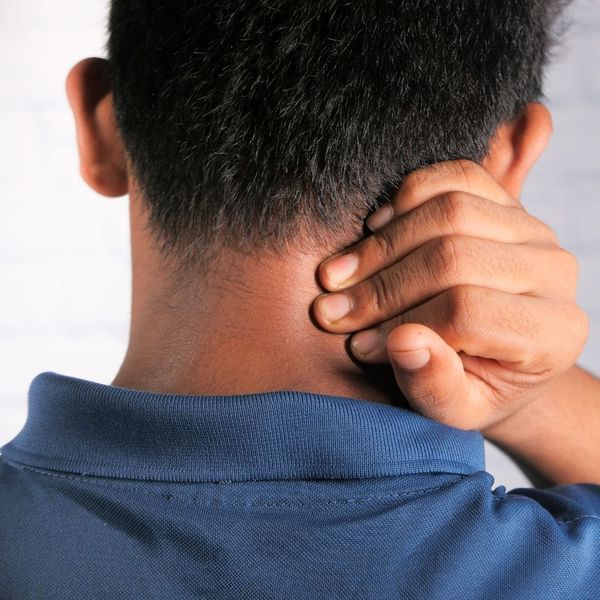 man holding neck in pain