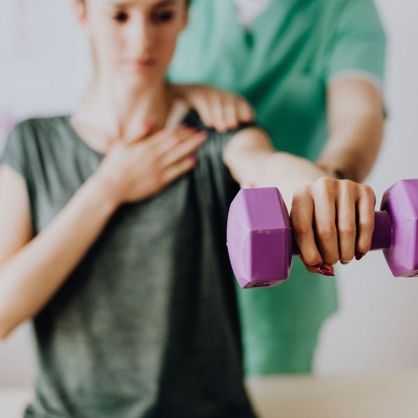 woman strengthening her shoulder with corrective exercises