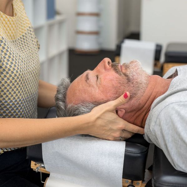a man getting chiropractic care for his injured neck