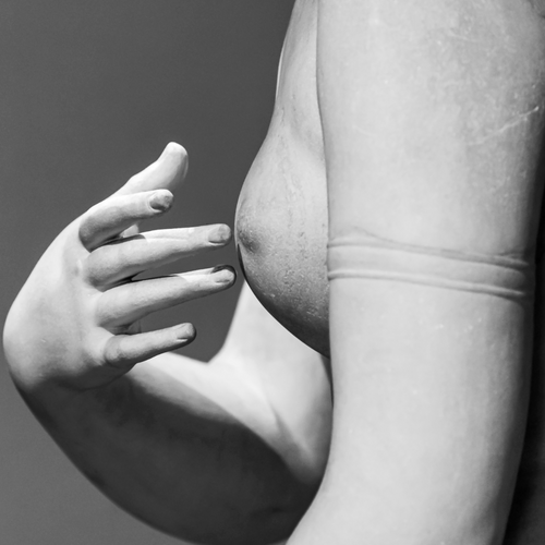 Black and white classical statue detail representing restoration, healing, and the human form
