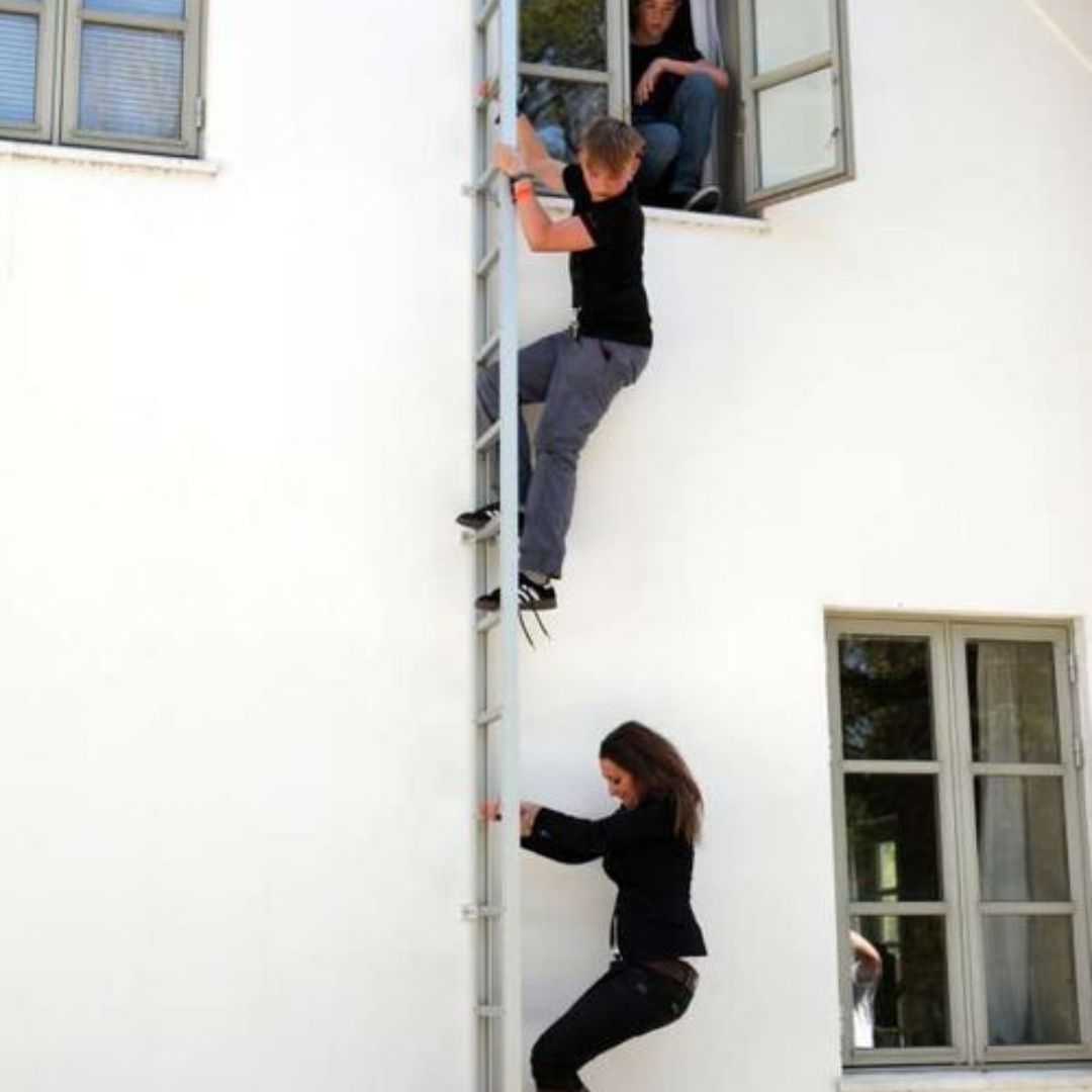 Children climbing down Modum Fire escape ladder