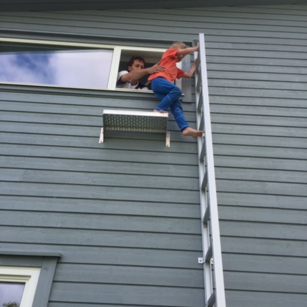 image of a kid using a fire escape ladder