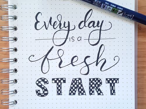 image of “Every Day is a Fresh Start” written in a notepad.