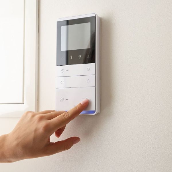 person using a smart thermostat
