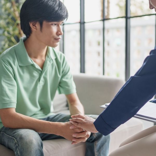 holding hands and talking to young man