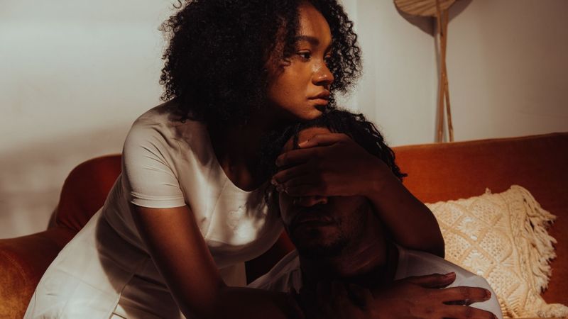 woman hugging man who is upset