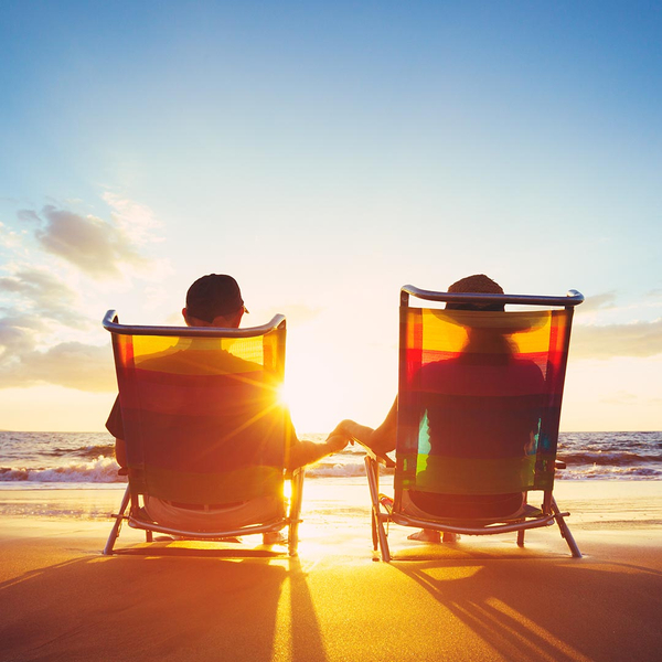 Couple sitting in beach chairs at the beach on vacation