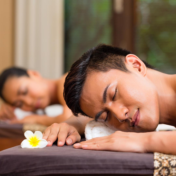 Relaxed couple getting massages at a spa