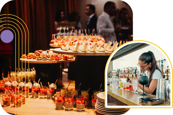 a table full with catered food and a bartender pouring drinks