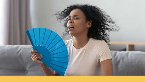 woman cooling herself off with fan
