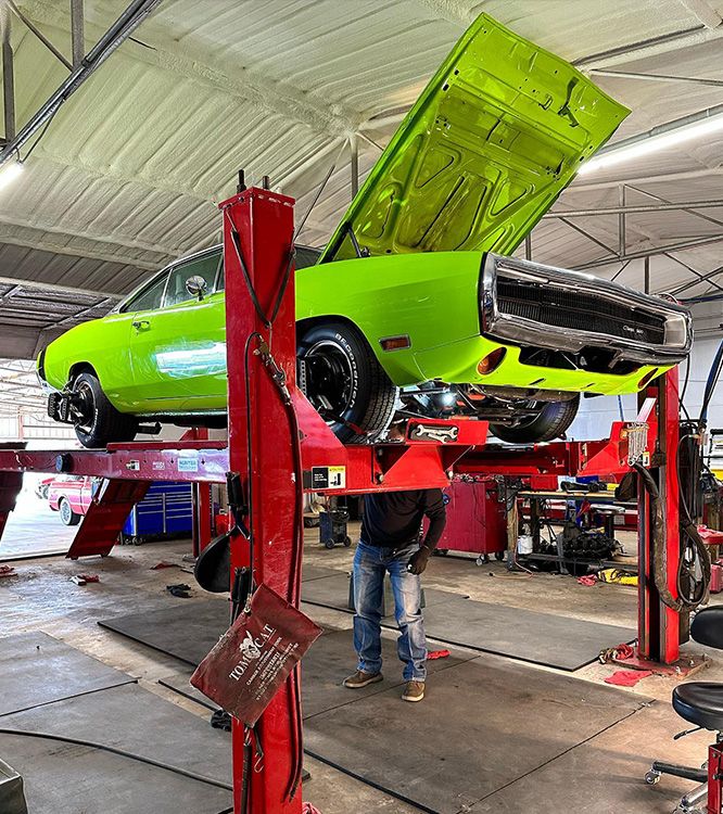 Green car on a lift