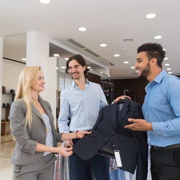group talking about coat at clothing store