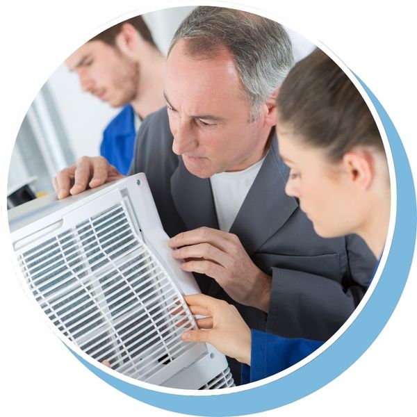 HVAC techs inspecting heater