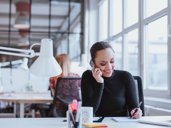 woman on phone in office building