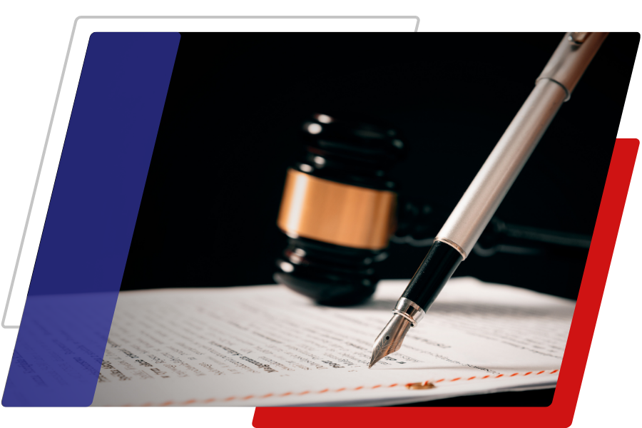 Image of a pen on a document with a gavel in the background
