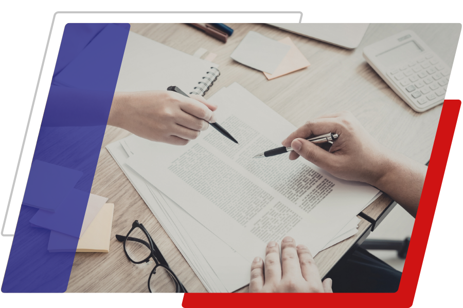 Image of two people going over documents with pens