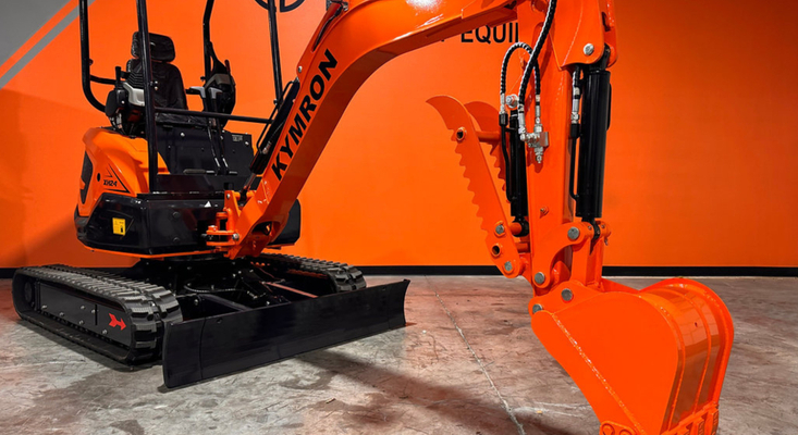 A professional contractors M Cross C Equipment Kymron mini excavator at a worksite.