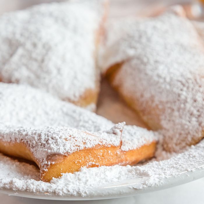 Beignets in a plate with sugar in top