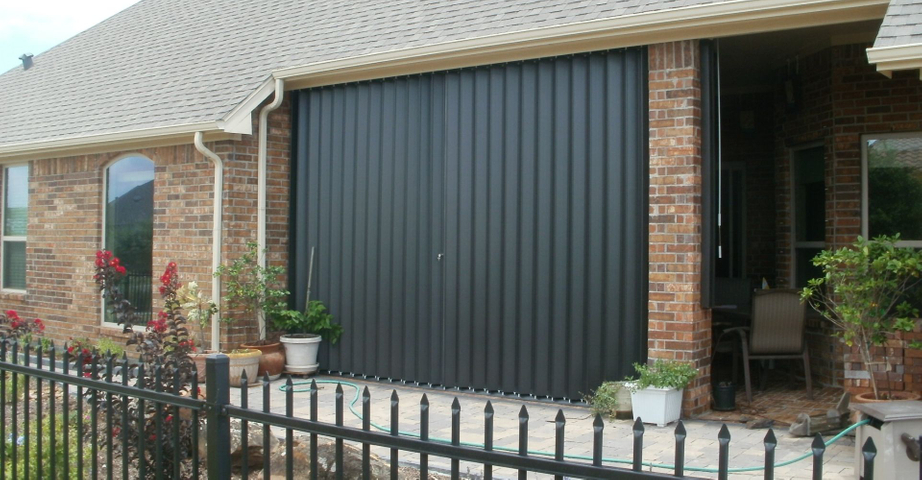 accordion shutters on a brick home window