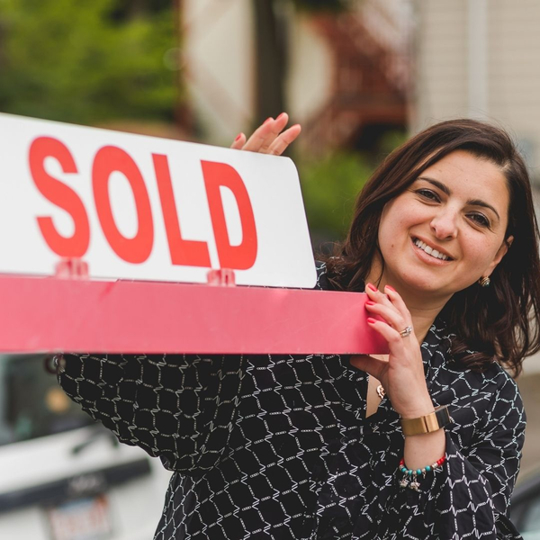happy woman with sold sign happy woman with sold sign