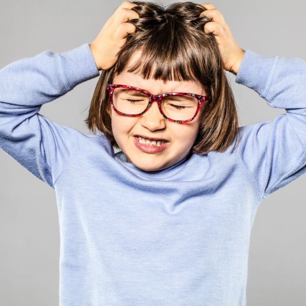 young girl scratching head young girl scratching head