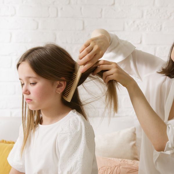 Parent checking for lice.