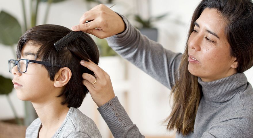 Parent checking for lice.