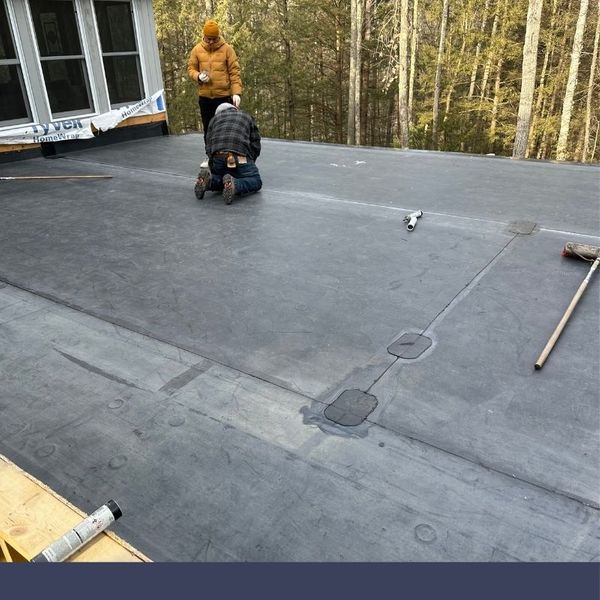 two roofing contractors working on a roofing project