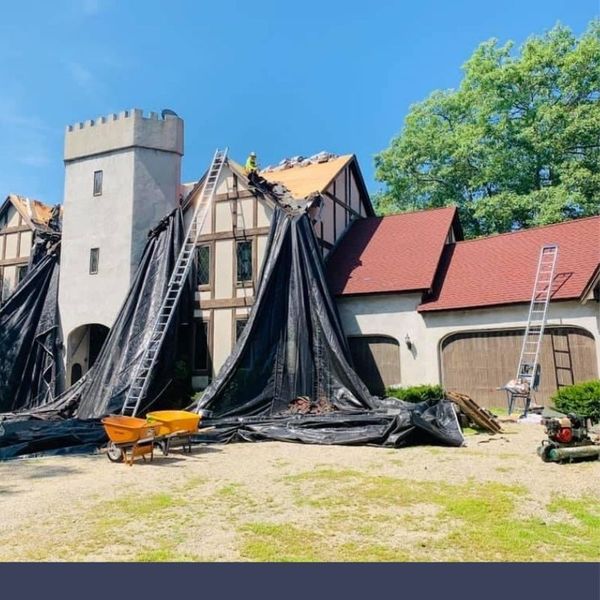roofers on top of house 