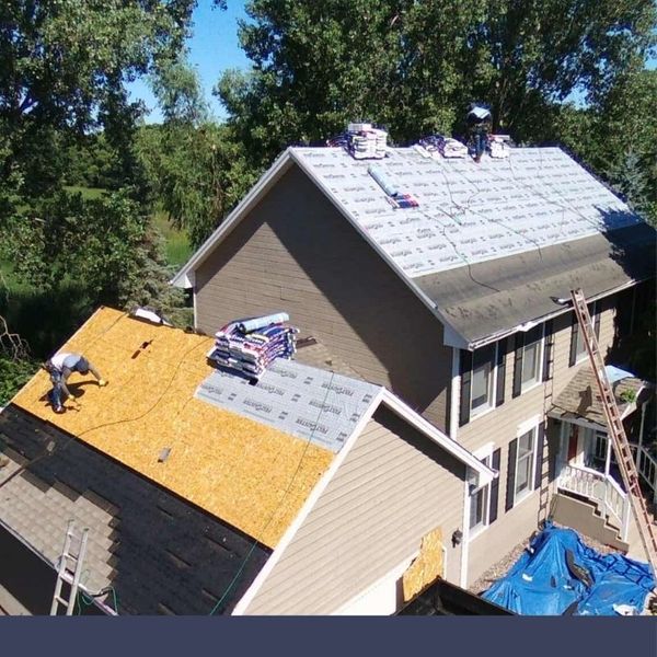 roofers on top of building