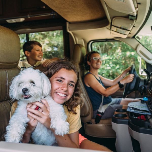 Family and their dog traveling in an RV