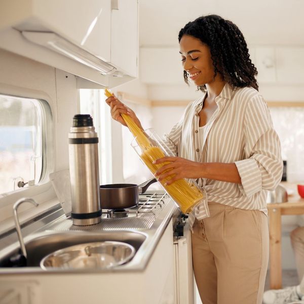 Woman preparing pasta in RV kitchen