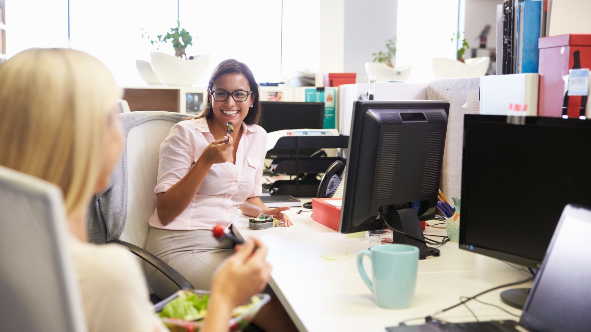 two women eating at work