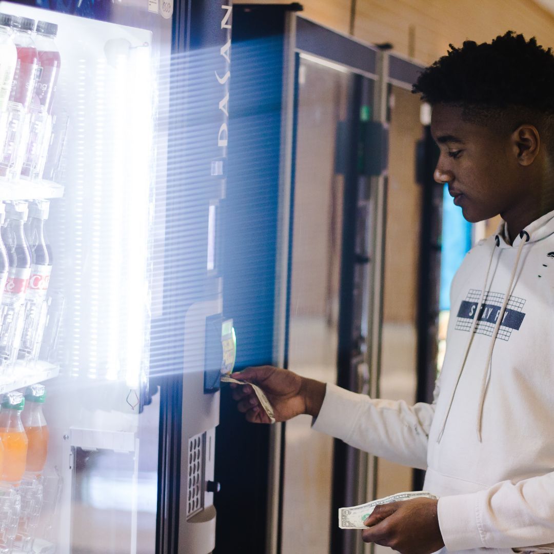 Man putting money in the vending machine