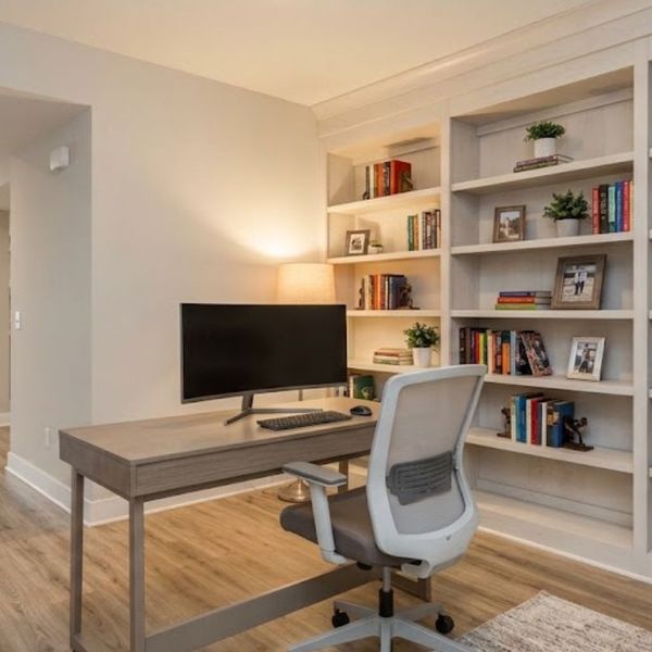 modern basement home office setup showing the versatility of the space with built-in bookshelves