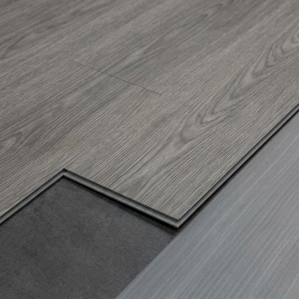 Detailed close-up showing installation of durable gray luxury vinyl plank flooring