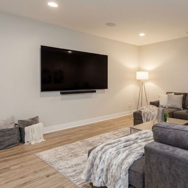 basement living room with large tv