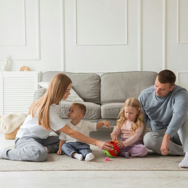 Family playing with young children in their newly remodeled basement