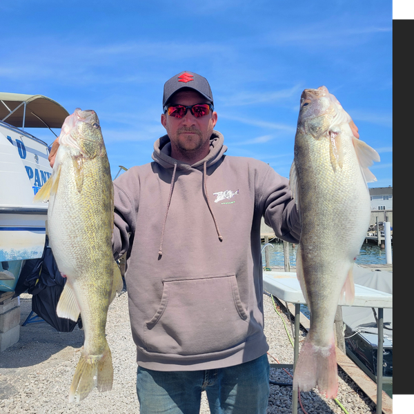 man holding up two fish