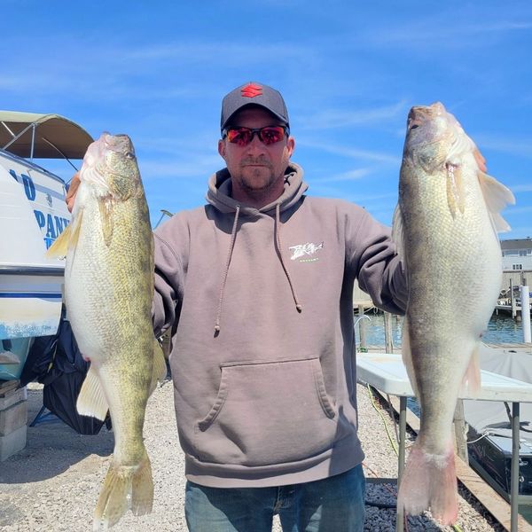 holding two large walleyes