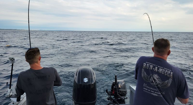 two men fishing from boat