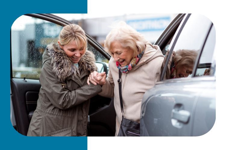 Person helping a senior adult exit a car