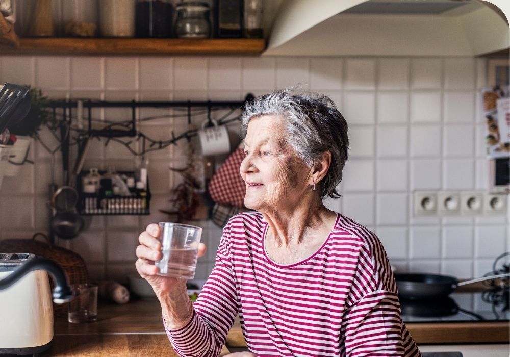 Elderly woman drinking water