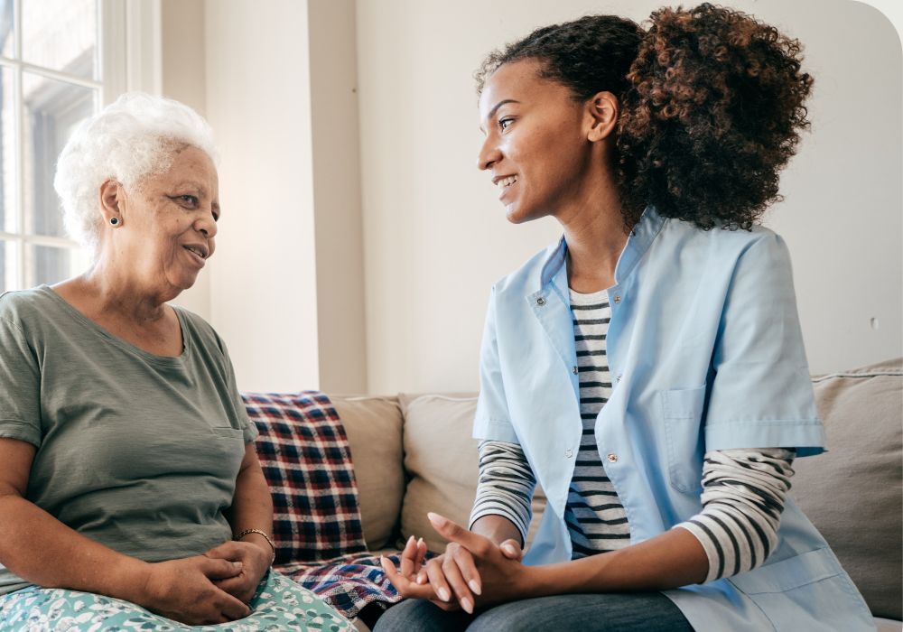 an in home nurse talking with her client