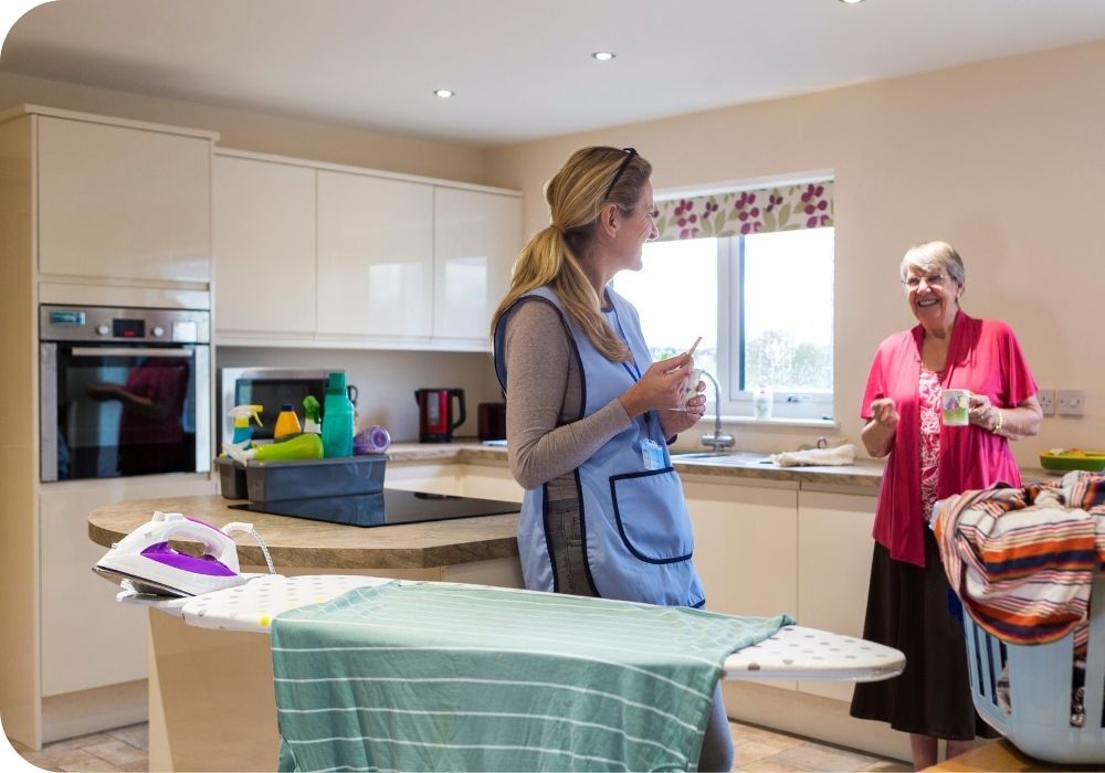 Housekeeper talking with elderly woman