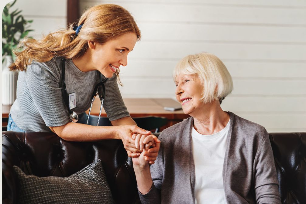 care taker holding womans hand