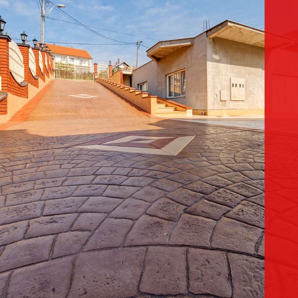 Home with stamped concrete driveway and walkway steps up to home