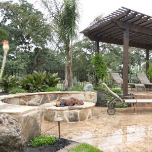 Home with concrete pool deck, fire pit, and seating